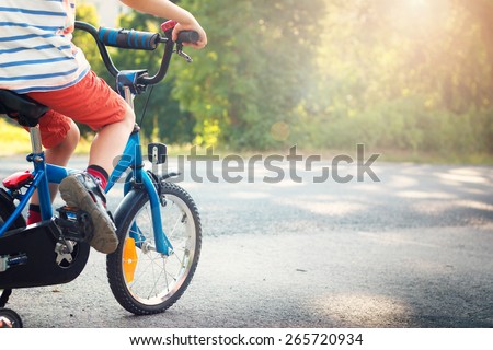 child on a bicycle at asphalt road