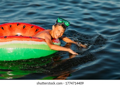 child on an inflatable circle swims on the sea, in the summer resting on the sea. little boy has fun and swims on an inflatable circle