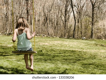 Child On An Old-fashioned Tree Swing