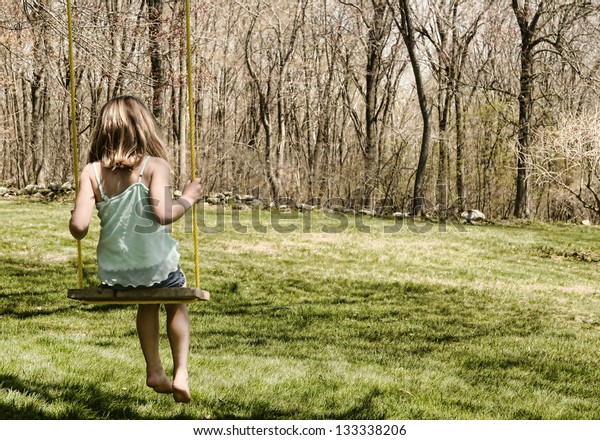 Child On Oldfashioned Tree Swing Stock Photo Edit Now