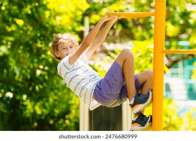 Child on playground. Active kid exercising in school yard. Children play and climb. Little boy on monkey bars. Kids having fun on sunny summer day in beautiful park. - Powered by Shutterstock