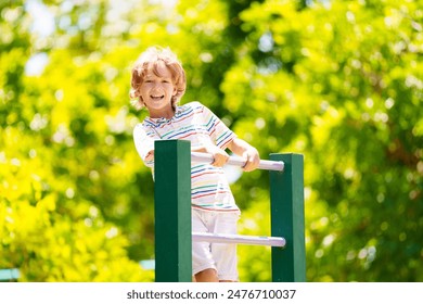 Child on playground. Active kid exercising in school yard. Children play and climb. Little boy on monkey bars. Kids having fun on sunny summer day in beautiful park. - Powered by Shutterstock