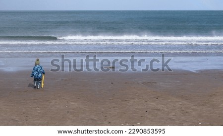 Child on a sandy beach on a sunny day in Summer