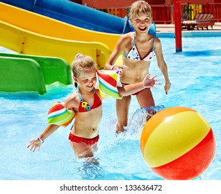 Child On Water Slide At Aquapark. Summer Holiday.