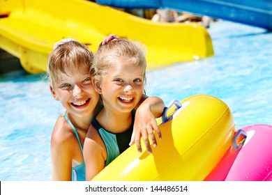 Child On Water Slide At Aquapark. Summer Holiday.