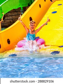 Child On Water Slide At Aquapark. Summer Holiday.