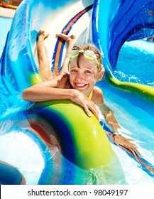 Child On Water Slide At Aquapark. Summer Holiday.