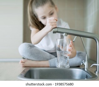 Child Open Tap. Kitchen Faucet. Filtration System, Water Purification At Home. Hydration. Healthy Lifestyle. Water Quality Check Concept. World Water Monitoring Day. Environmental Pollution Problem