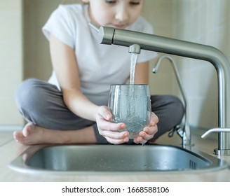 Child Open Water Tap. Kitchen Faucet. Glass Of Clean Water. Pouring Fresh Drink. Hydration. Healthy Lifestyle. Water Quality Check Concept. World Water Monitoring Day. Environmental Pollution Problem