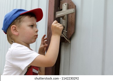 Child Opening Lock Of A Door With Key