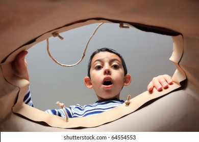 child opening shopper and looking inside with surprise