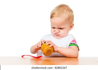 Child Opens A Jar Of Puree