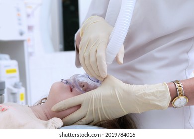 Child With An Oxygen Mask On His Face. Preparing The Child For Surgery. The Child Is Under Anesthesia. Life Saving. Oxygen Mask. Health Care Concept.