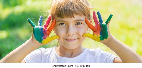child with painted hands and legs. Selective focus.