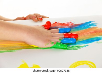 a child painting with finger paints. funny and creative.
