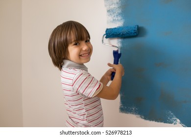 Child Painting The Home Wall In Colors