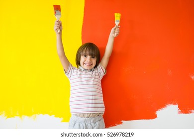 Child Painting The Home Wall In Colors