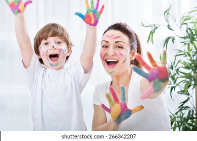 Child painting and mum