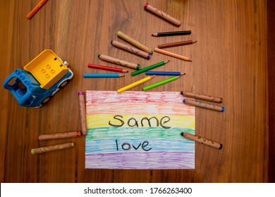 Child Painting On A Wooden Table Reading; 