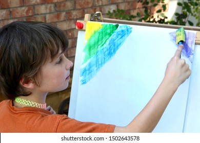 Child Painting A Picture Outside