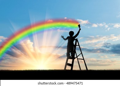 Child paints a rainbow in the sky at sunset - Shutterstock ID 489475471