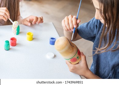 A Child Paints A Wooden Blank Of A Nesting Doll. Children's Crafts