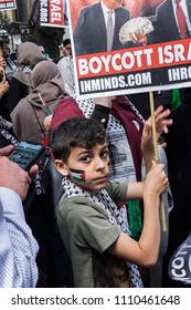 A Child With The Palestinian Flag Pained On His Cheek Holds A Sign Calling For People To Boycott Israel. Al Quds Day Rally, London, 10/06/18.

