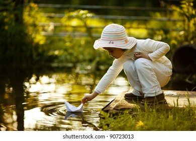 Child With A Paper Boat