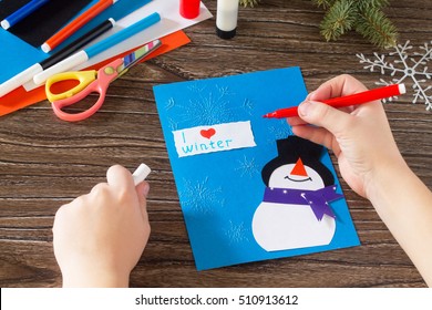 Child Paper Glued Parts That I Love Winter. The Child Makes A Greeting Card With A Snowman. Made With His Own Hands. Children's Art Project, A Craft For Children. Craft For Kids.