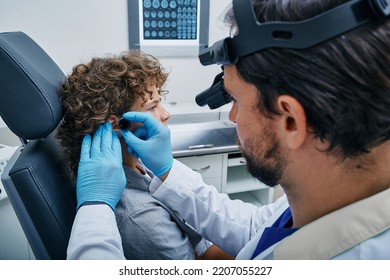 Child Patient During Ear Exam With Doctor Pediatrician In ENT Office At Medical Clinic. Ear Check-up, Otolaryngology