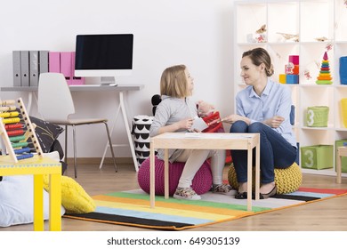 Child With Pedagogue During The Session Of Play Therapy 