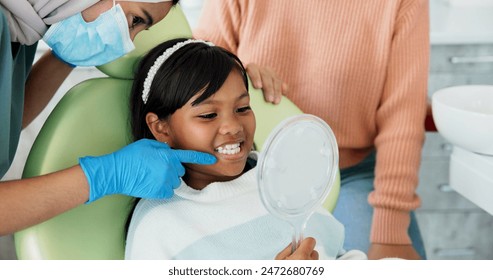 Child, pediatric dentist or checkup of teeth in surgery or family friendly examination of tooth. Girl, parent and support in orthodontist chair for trust and gentle with mirror for kids dental care - Powered by Shutterstock