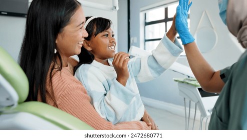 Child, pediatric dentist and high five in checkup, trust and good job for oral hygiene or healthy teeth. Girl, parent and support in consultation by orthodontist and congratulations for clean mouth - Powered by Shutterstock