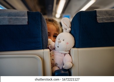 Child Peeking Between Seats.Child Sitting In Front Seat.Children On Plane/bus/train Rides.Children In Transportation. Annoying Kid.Airplane Child Passenger,traveling With Kids.Bringing Toys To Trips