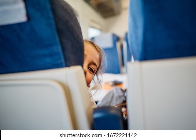 Child Peeking Between Seats.Child Sitting In Front Seat.Children On Plane/bus/train Rides.Children In Transportation.Anoying Kid.Airplane Child Passenger,traveling With Kids.