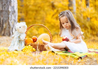 Child Picking Apples On A Farm In Autumn. Kid Girl Pick Fruit In A Basket. Toddler Eating Fruits At Fall Harvest. Outdoor Fun For Children. Healthy Nutrition. Leaves Falling.