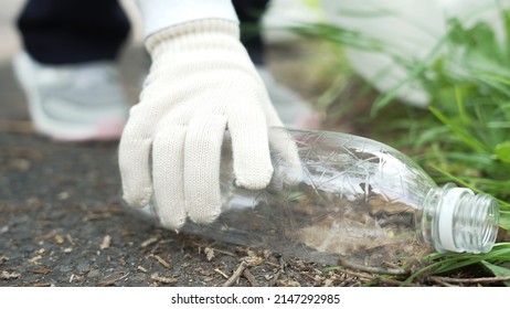 Child Picking Up A PET Bottle On The Street. Litter Cleanup Activities. Environment Protection. Recycling.