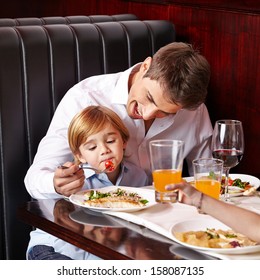 Child Is A Picky Eater In Restaurant And Father Tries To Feed It