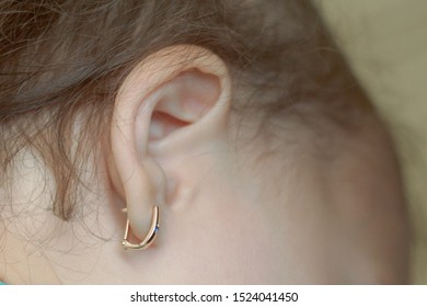 The Child With The Pierced Ears Is Younger Than Three Years