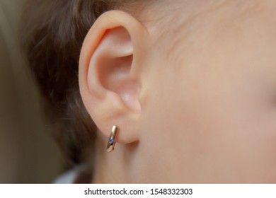 The Child With The Pierced Ears Is Younger Than Three Years