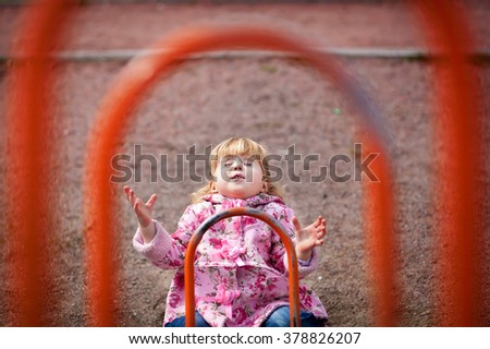 Similar – Happy little girl playing in a urban playground.