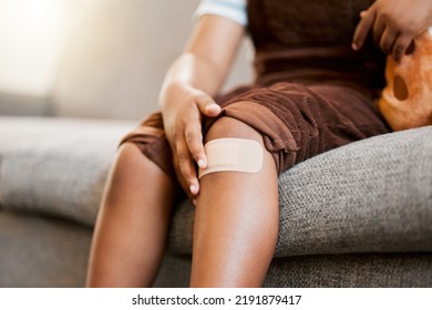 Child With Plaster Or Bandaid, Injured And Hurt By Accident While Playing A Sport, Exercise Or Outside Closeup. Kid With A Medical Bandage After Help On Wound, Injury Or Scratch On Skin, Knee Or Leg