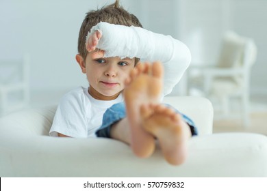 A Child With A Plaster On His Hand