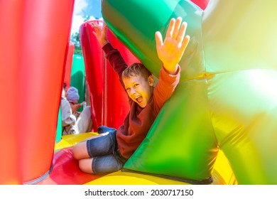 Child play on colorful playground trampoline. Kids jump in inflatable bounce castle on birthday party.  Horizontal childhood poster, greeting cards, headers, website.