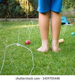 Child Playing Backyard Croquet With Diy Equipment