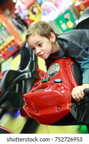 Child playing in bike simulator at indoor playground