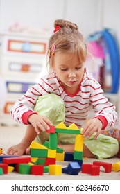 Child Playing With Blocks In The Kindergarten