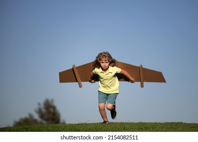 Child playing with cardboard toy wings in the park. Concept of children day. Kid boy in an pilot costume is playing and dreaming of becoming a aviator spaceman. Kids freedom concept. - Powered by Shutterstock