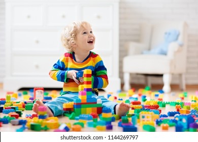 Child Playing With Colorful Toy Blocks. Little Boy Building Tower At Home Or Day Care. Educational Toys For Young Children. Construction Block For Baby Or Toddler Kid. Mess In Kindergarten Play Room.