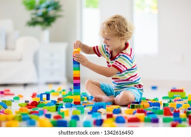 Child Playing With Colorful Toy Blocks. Little Boy Building Tower At Home Or Day Care. Educational Toys For Young Children. Construction Block For Baby Or Toddler Kid. Mess In Kindergarten Play Room.